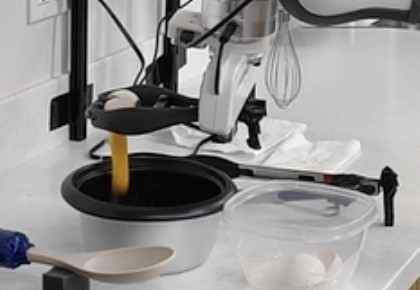 Egg cracker squeezed, egg dropping into the bowl
