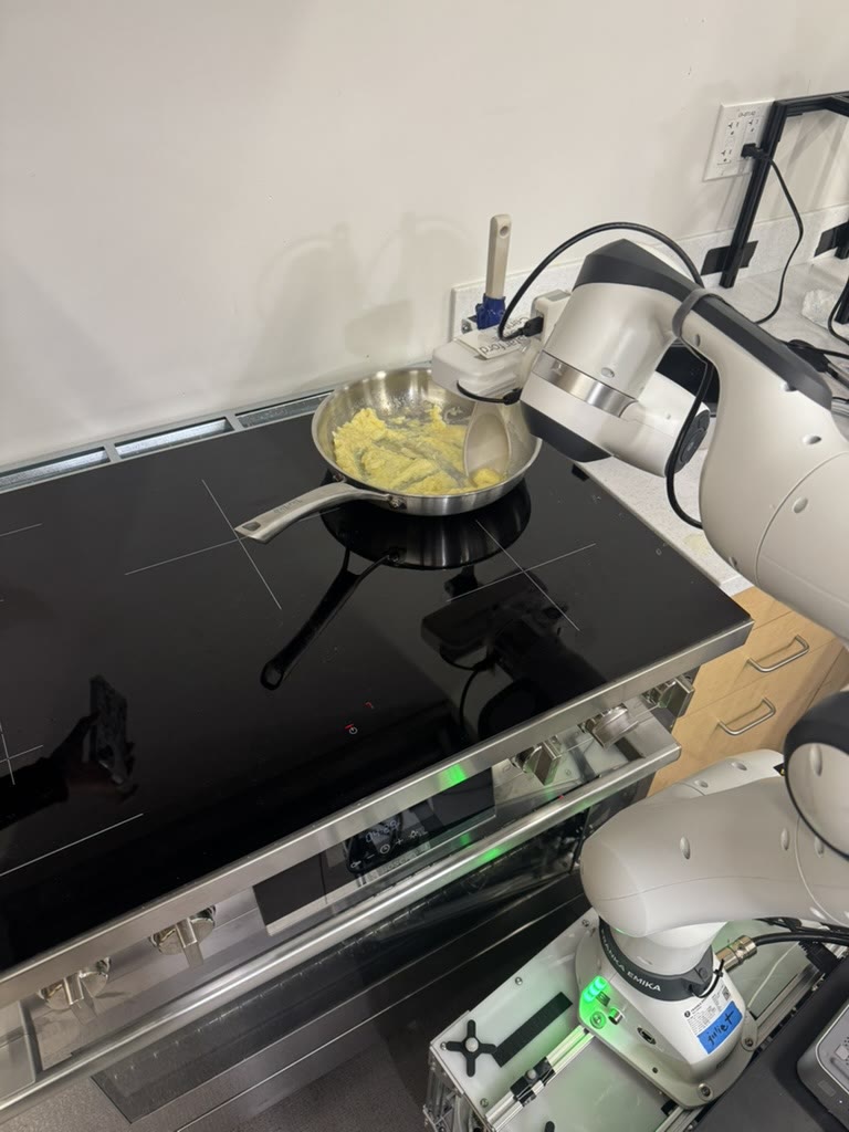 EggBot hardware: Franka arm on TidyBot base at the stove